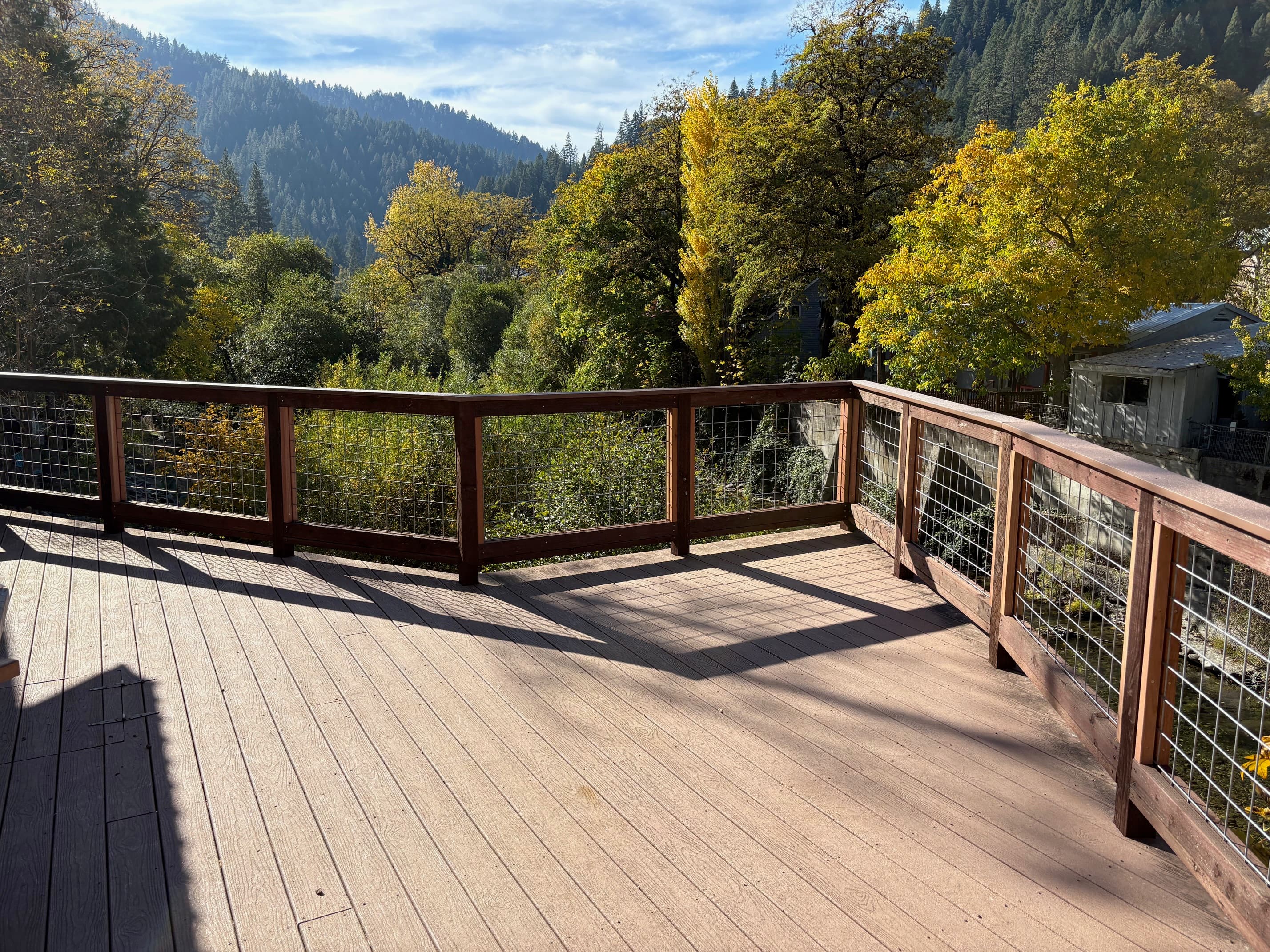 Custom redwood deck railing with Sierra Nevada mountain view — Sta-Bull Fence