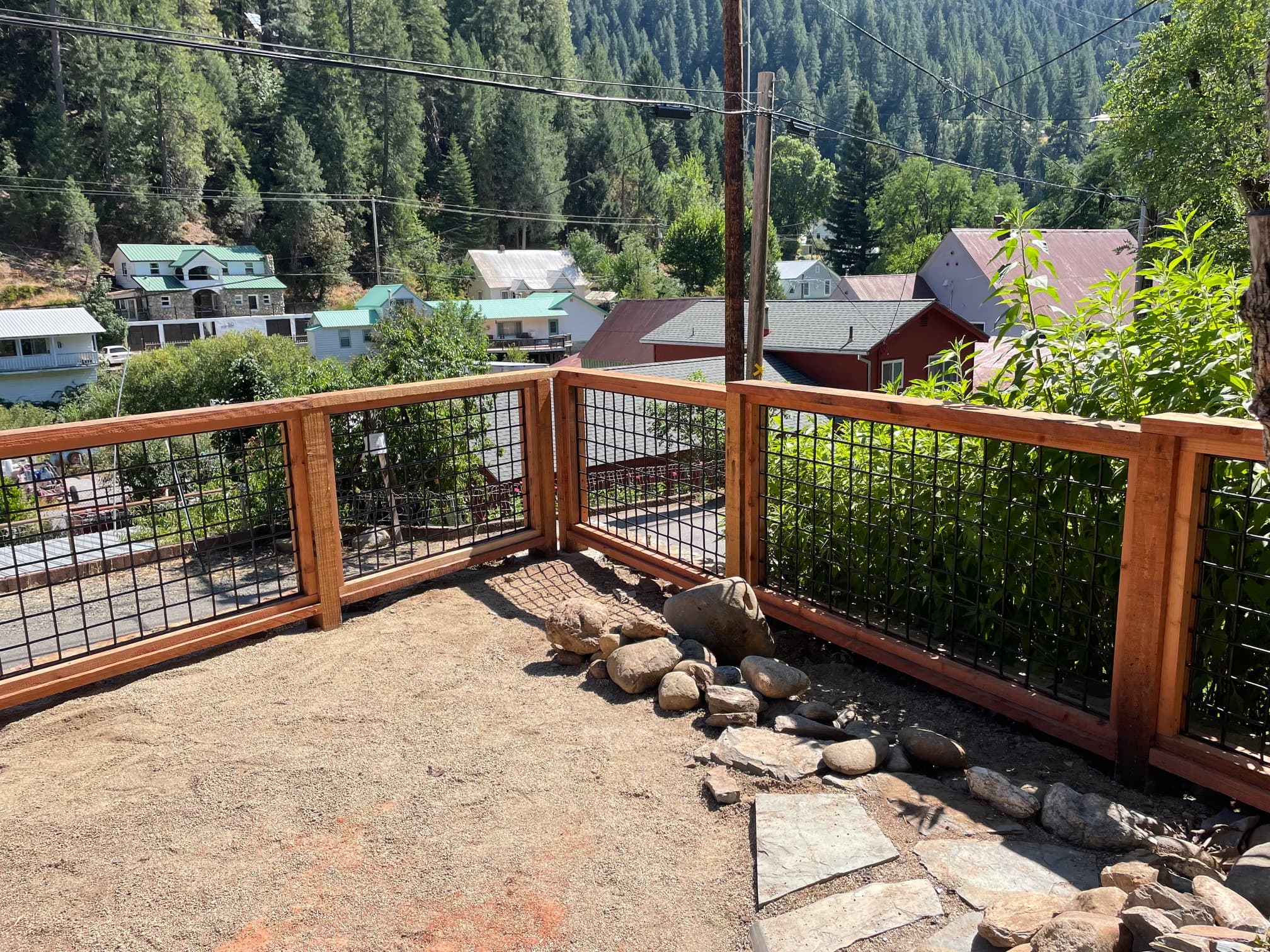 Custom wood frame and wire fence on hillside deck, Downieville CA