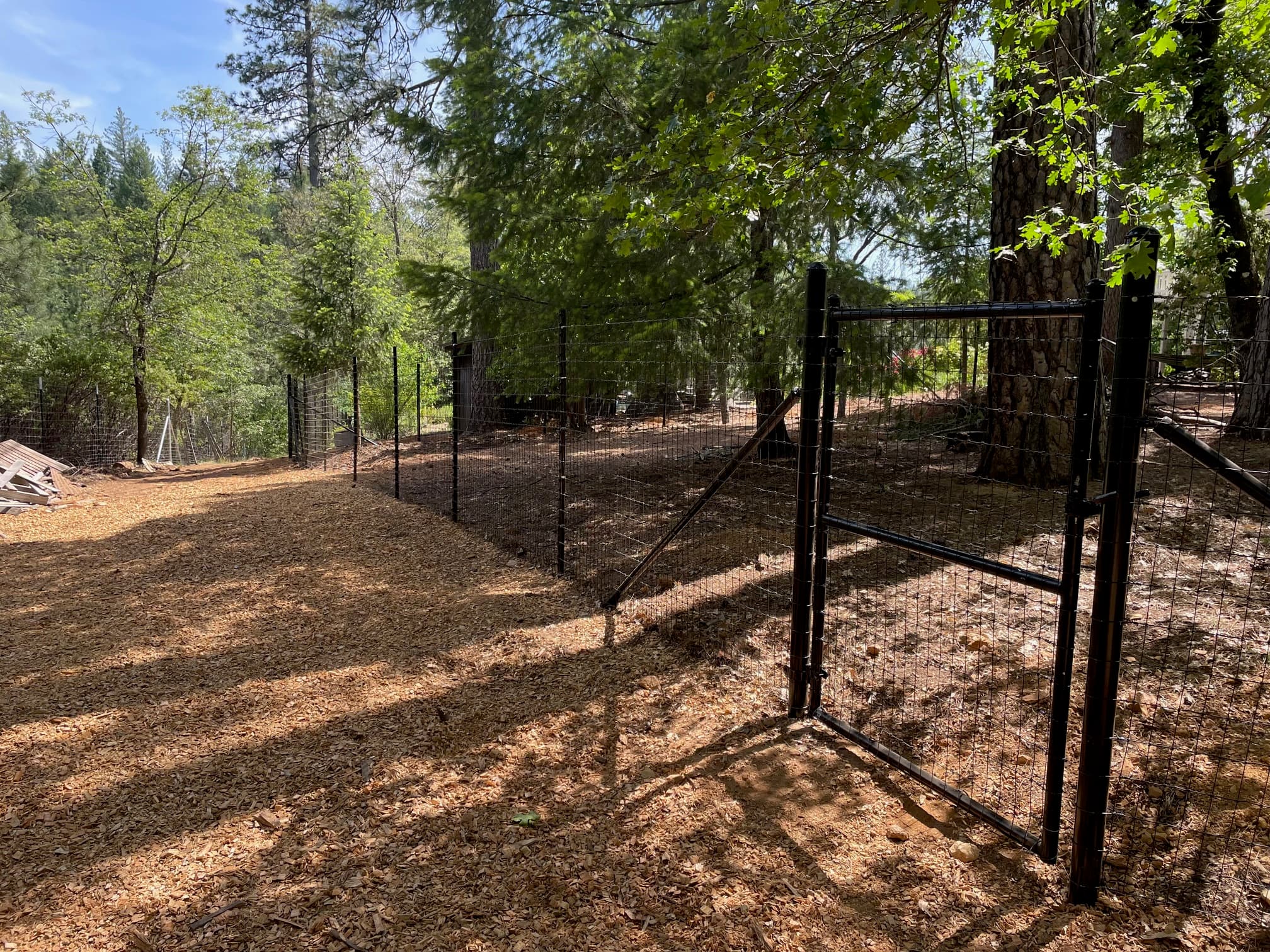 Black steel post and welded wire fence with custom gates, Nevada County